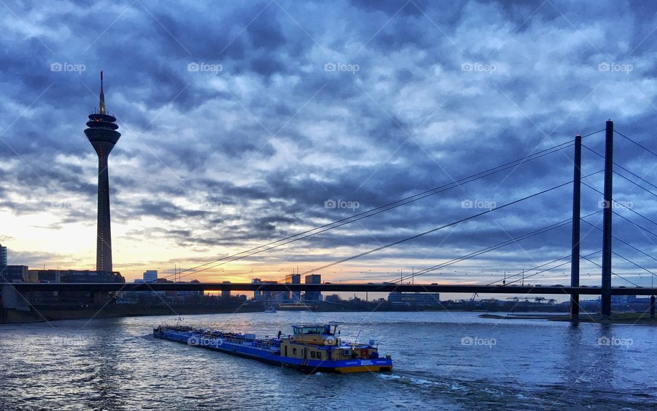 Ships ply the Rhine at sunset 