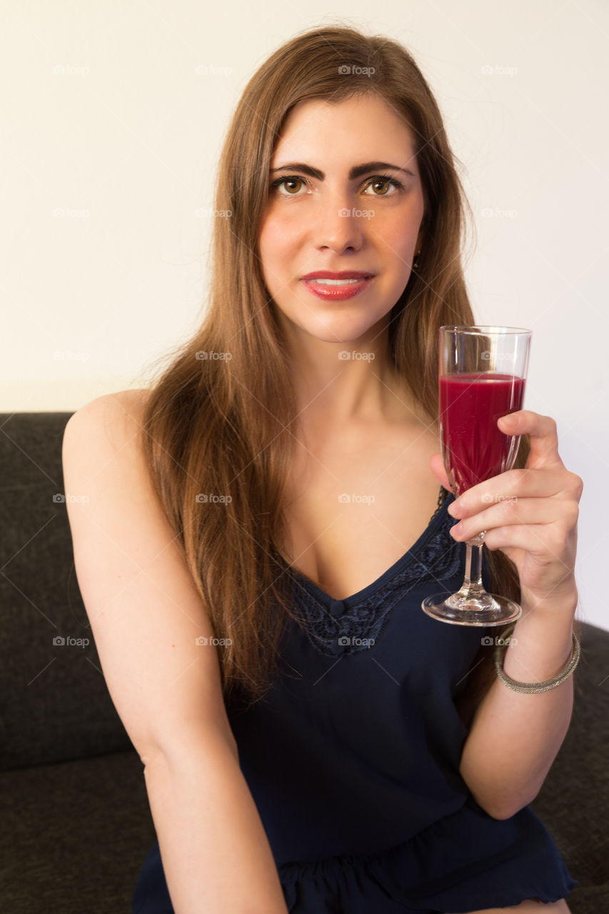 A young woman with a healthy fruit juice