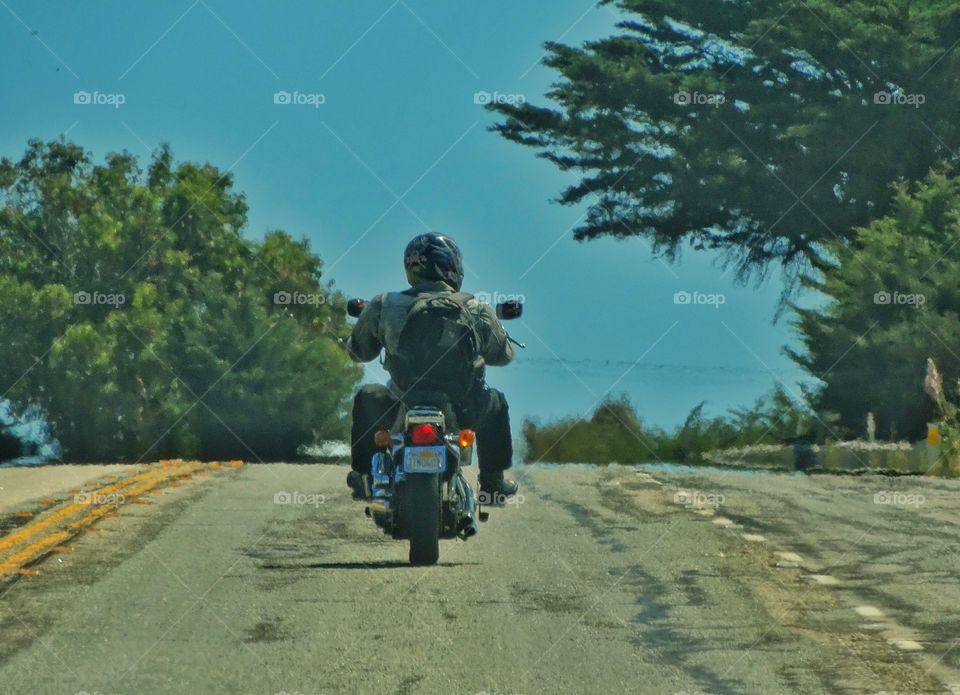 Motorcycle Touring. Lone Motorcyclist Driving On California's Pacific Coast Highway
