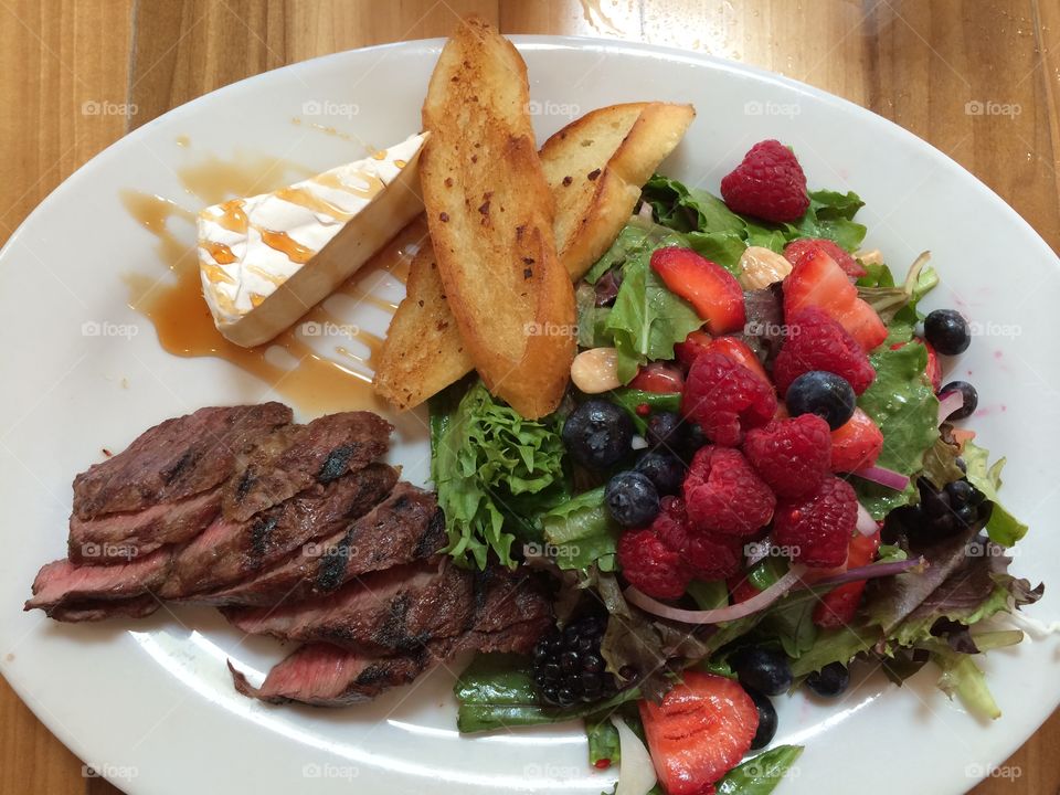 This BBQ has it all!!. Steak, spring salad and Brie. Yum!