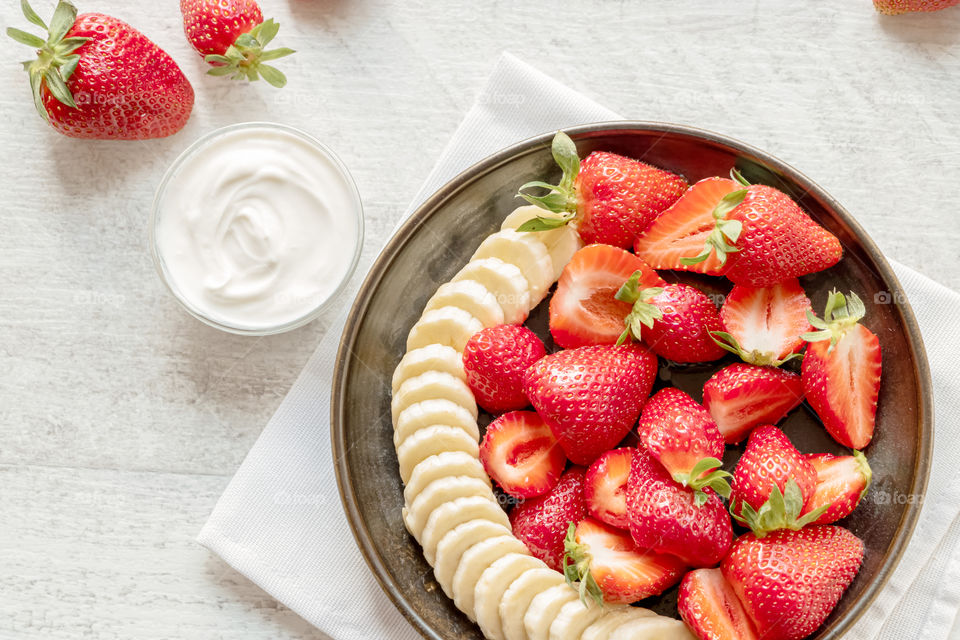 Fresh fruit salad made with strawberries and bananas. Concept of healthy lifestyle.