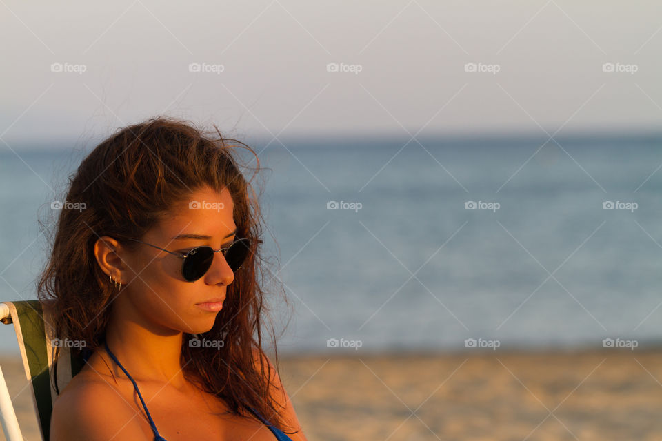 Beautiful girl sitting at the seaside
