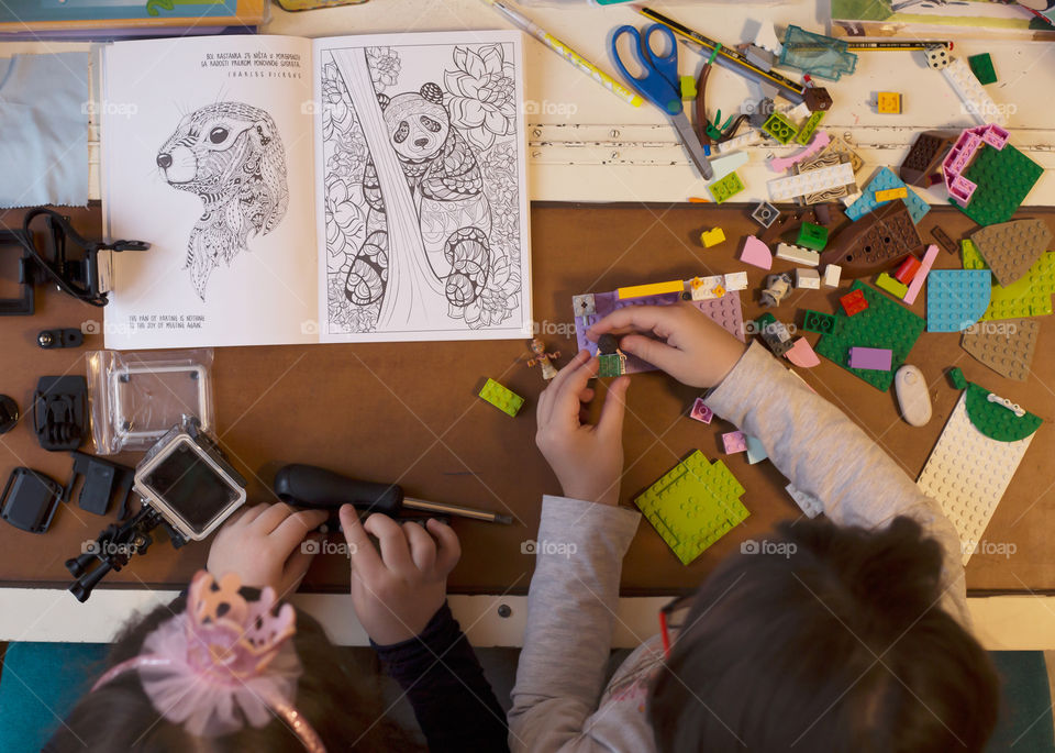 Two girls building and preparing while playing