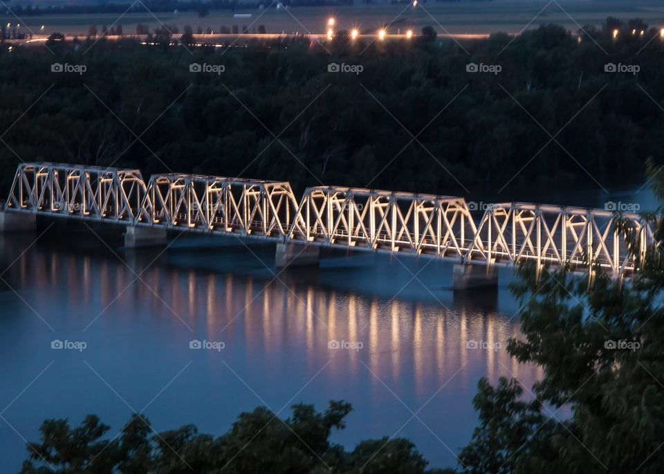 Train Bridge over water at night.