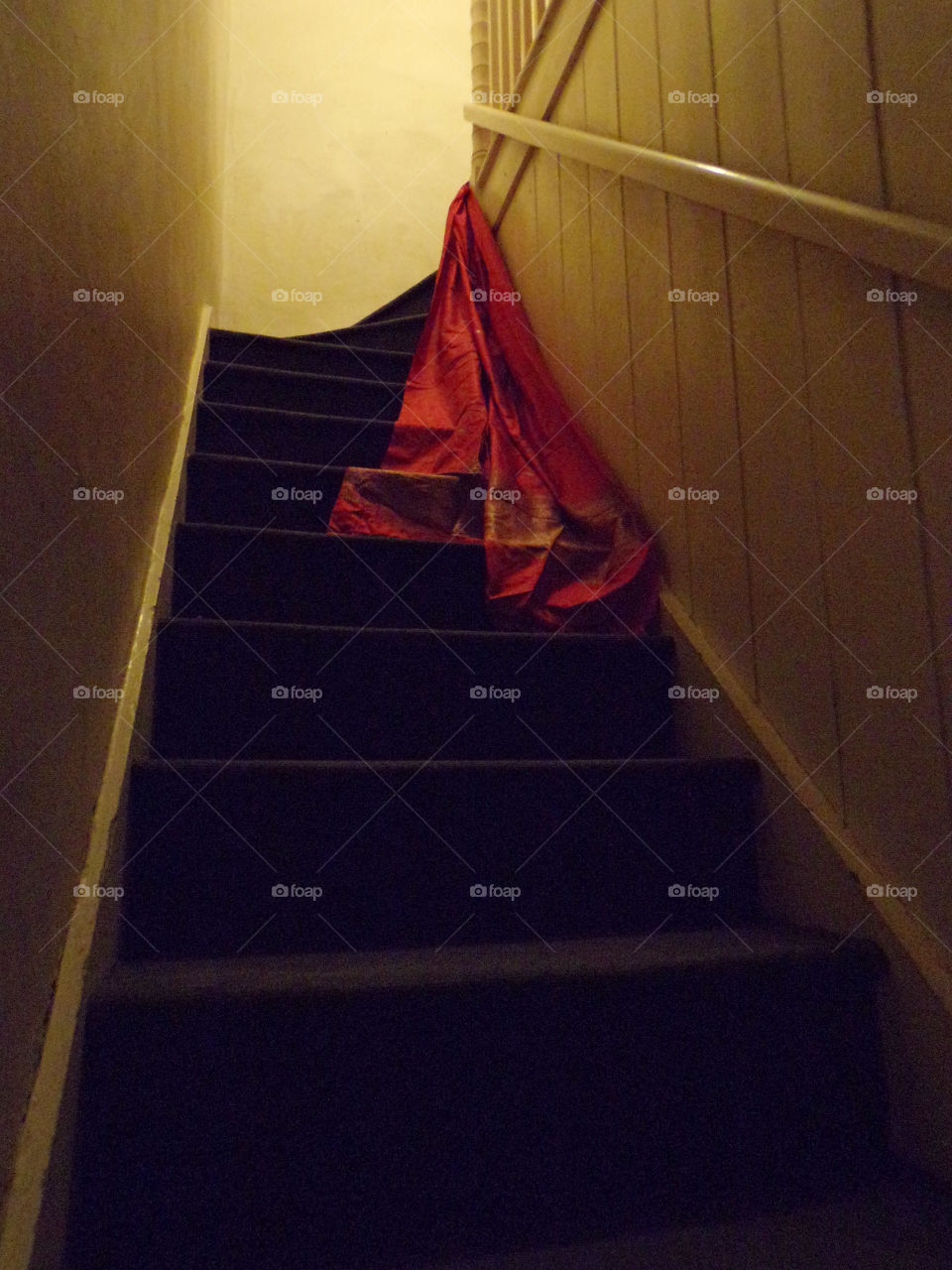 A red sari on the stairs of an old house