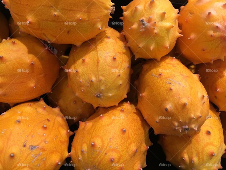 Kiwano fruit in a bin, orange and spiky