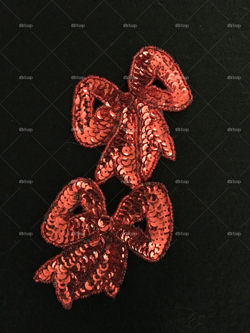 Two red sequin bows