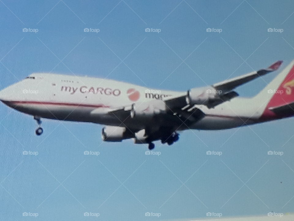 a huge cargo plane arriving at its destination with an exciting landing in the Blue Sky