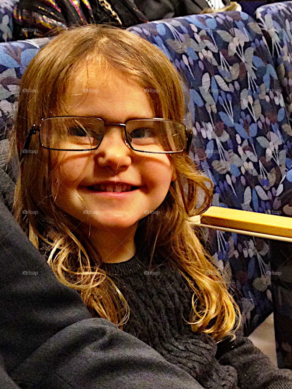 She is testing her grandfather's glasses!