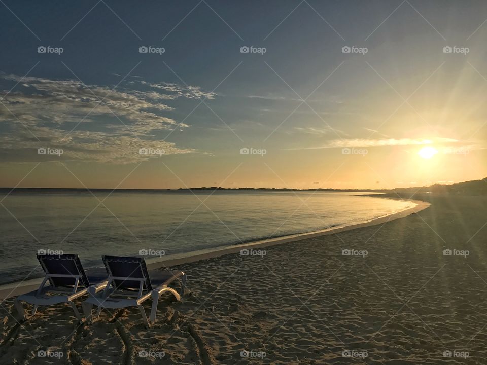 Two deck chairs at sea