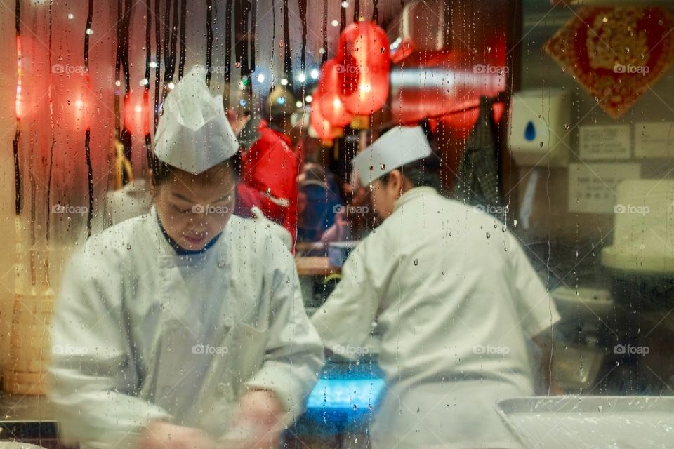 View trough the window of Chinese restaurant workers 