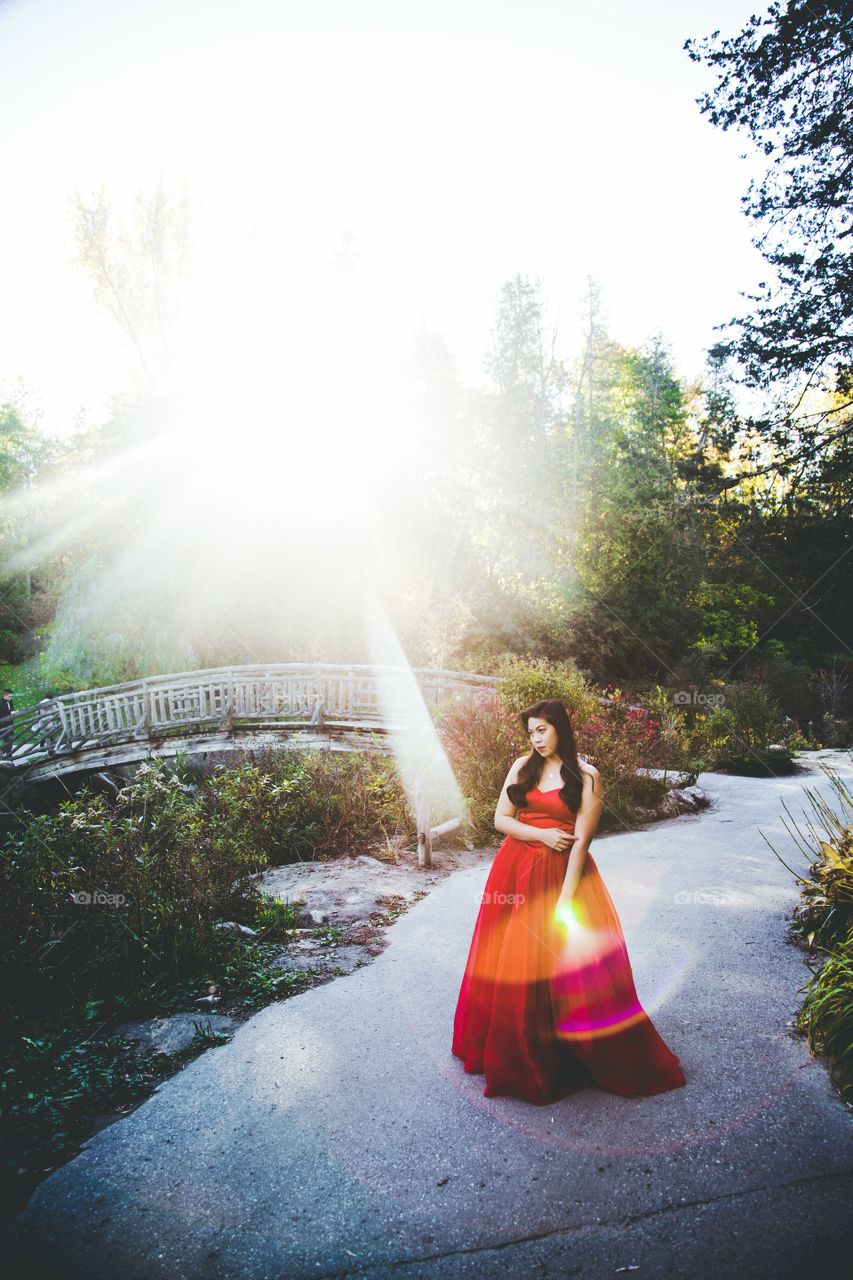 Portrait of young woman standing in park