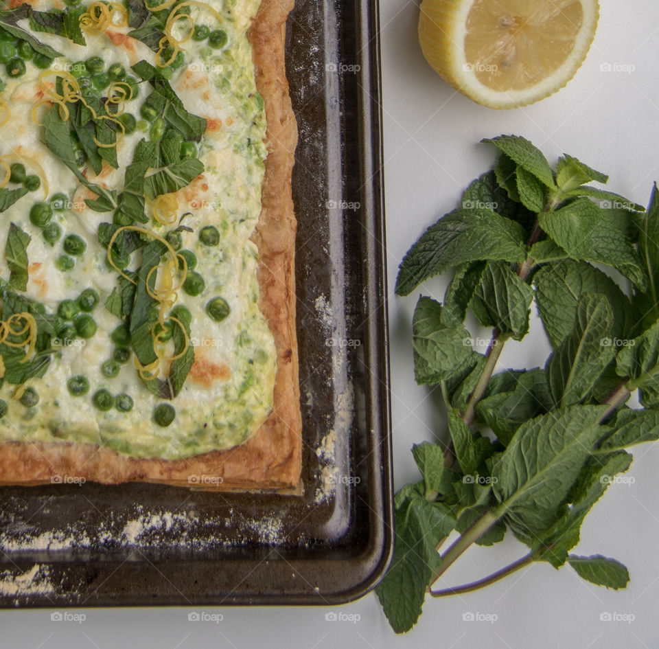 Baked lemon, pea, feta cheese puff pastry tart