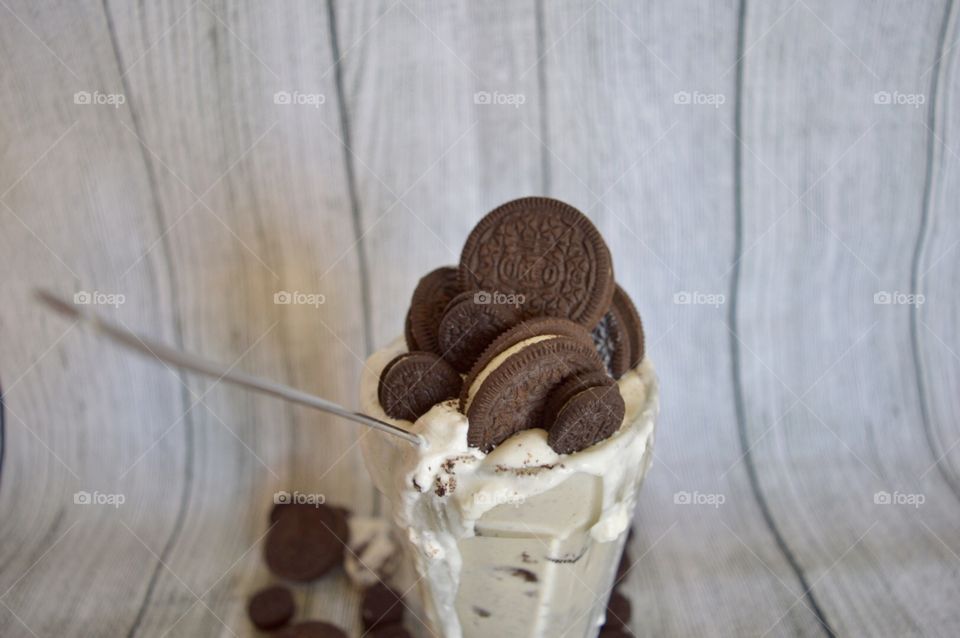Oreo cookie milkshake with a wooden rustic white background