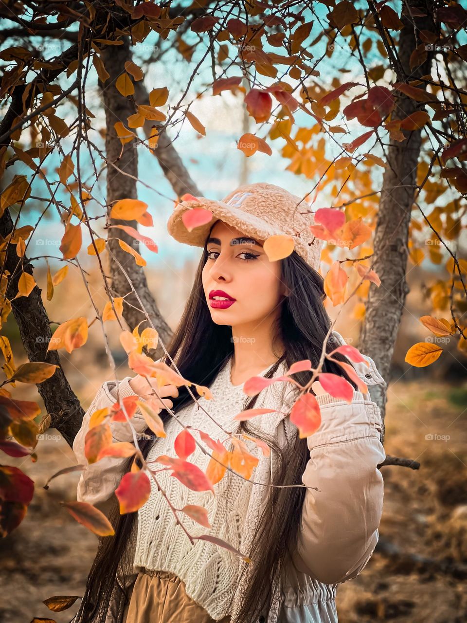 Portrait of a young girl among autumn leaves