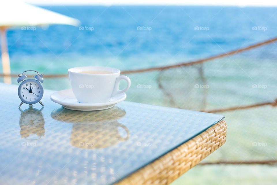 Tea cup with alarm clock