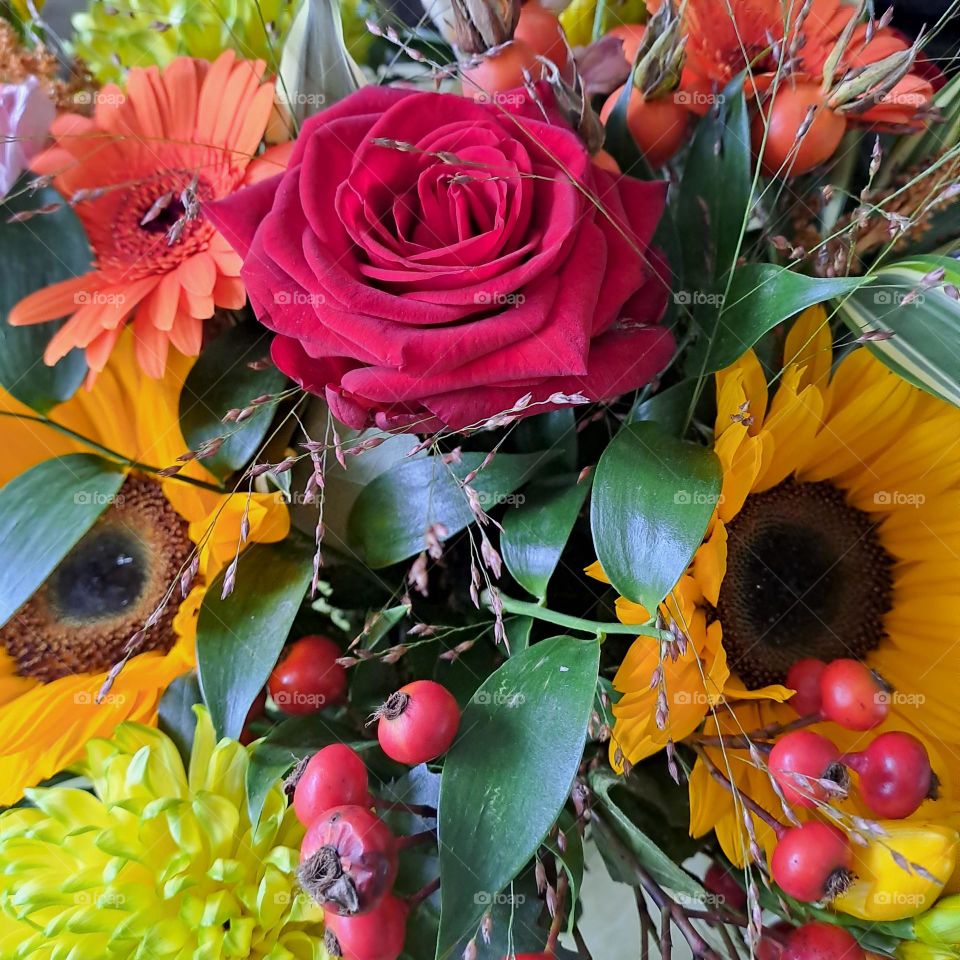 Bright colourful floral bouquet. flowers foliage berries, close up, autumnal palette
