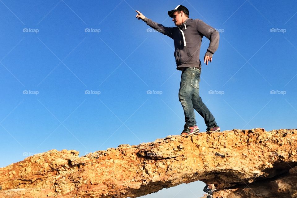 Man posing on cliffs