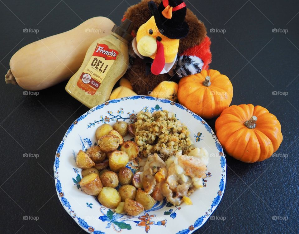 Thanksgiving plate of turkey in a creamy French’s deli  mustard sauce with stuffing and roasted potatoes.