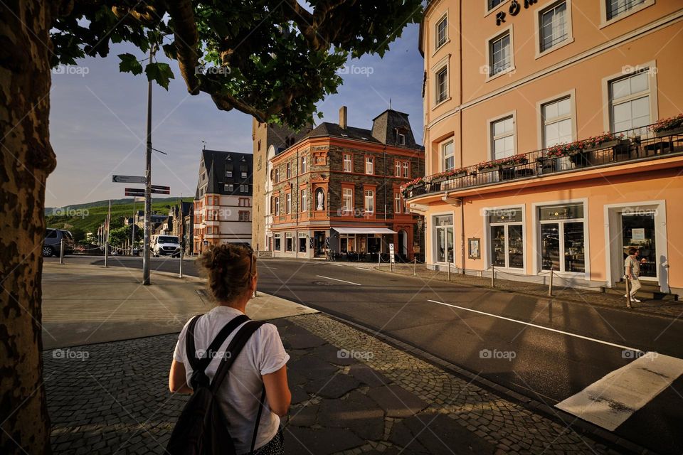 Rear view of woman in city on a summer evening. 