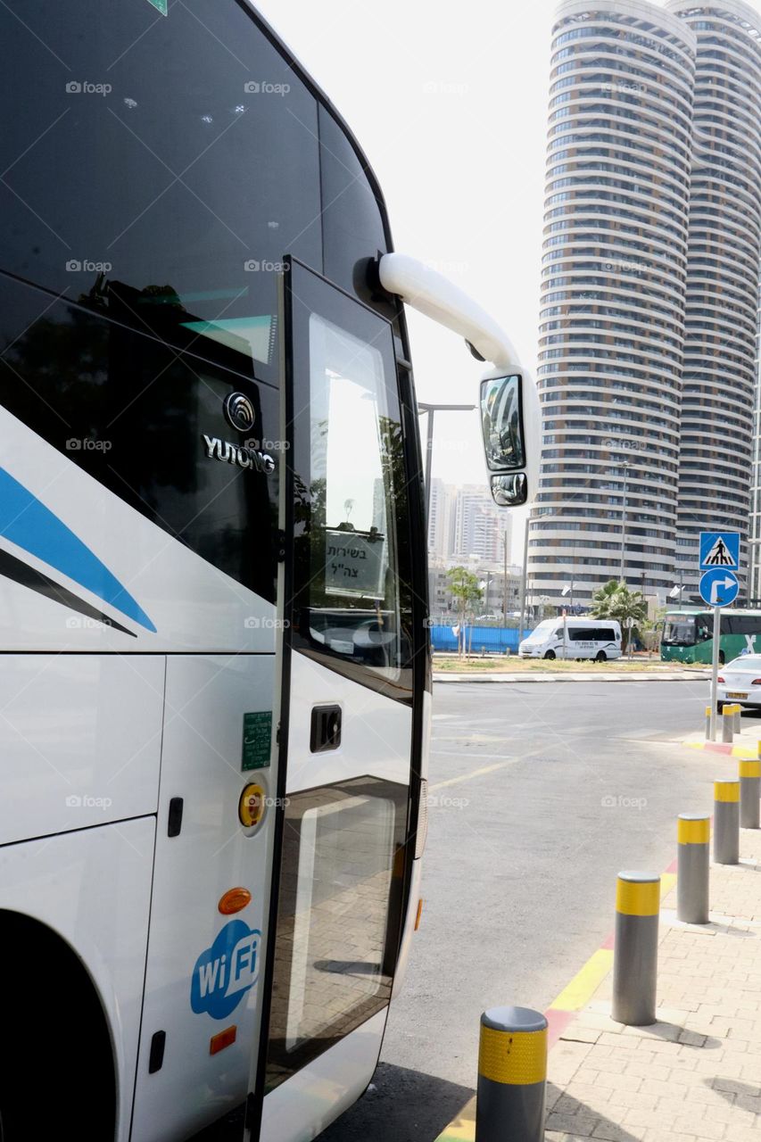 Bus stands in the bus station with open door