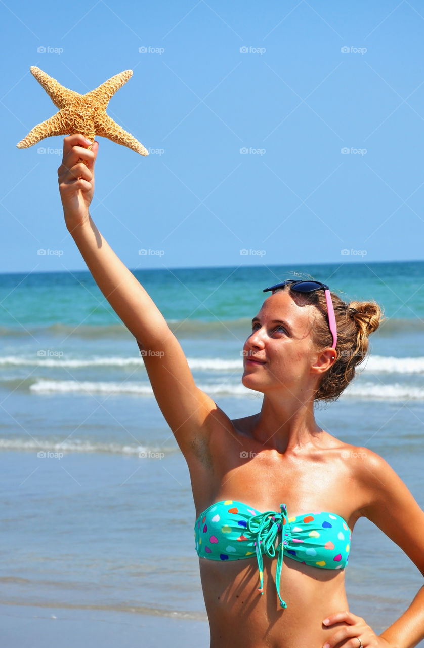 Woman holding star fish