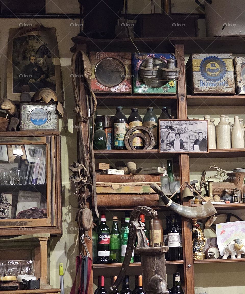 "Assortment of odds" Shelves in a restaurant (Pulperia) have antique objects; the painting, cow horn, locks, grinder, biscuit tins, as well as modern ones, such as bottles of wine or a child's drawing. It's fascinating!! and the food is delicious.