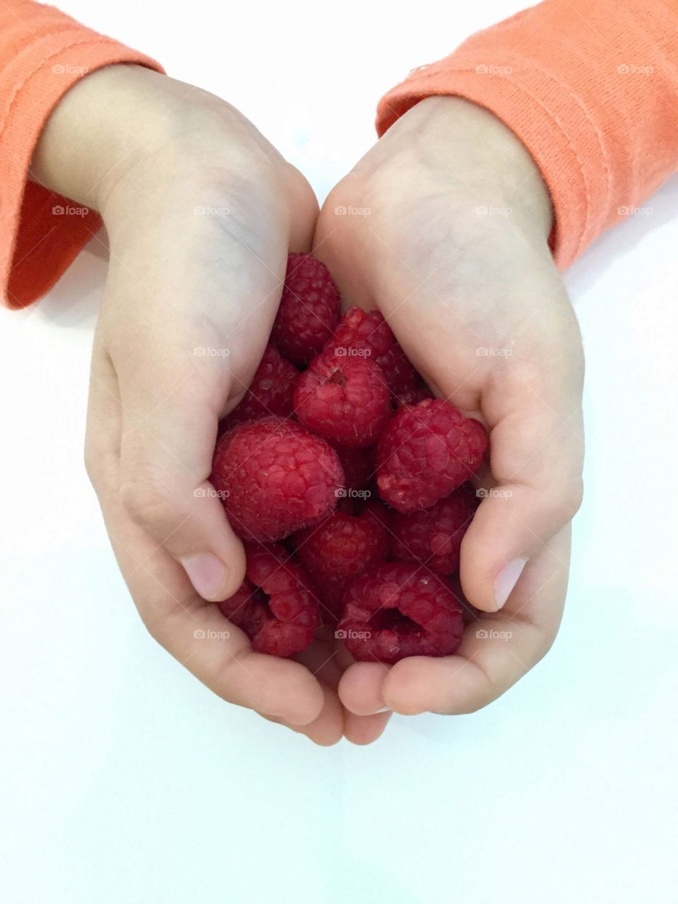raspberries in hands
