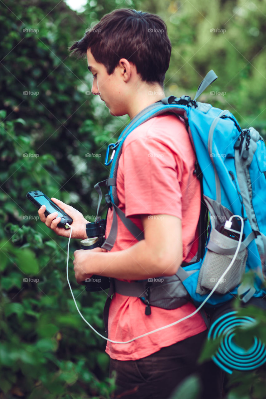 Close-up of a teenage boy holding mobile phone