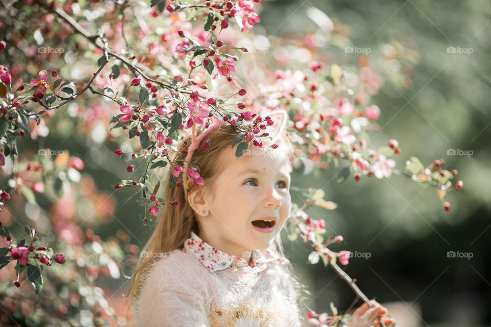 Cute Little girl in a blossom park