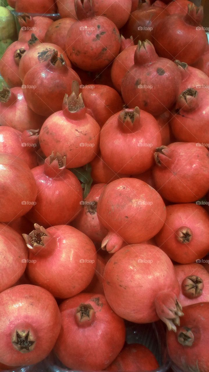 Abundence of red bright globe-shaped
healthy fresh pomegranates
