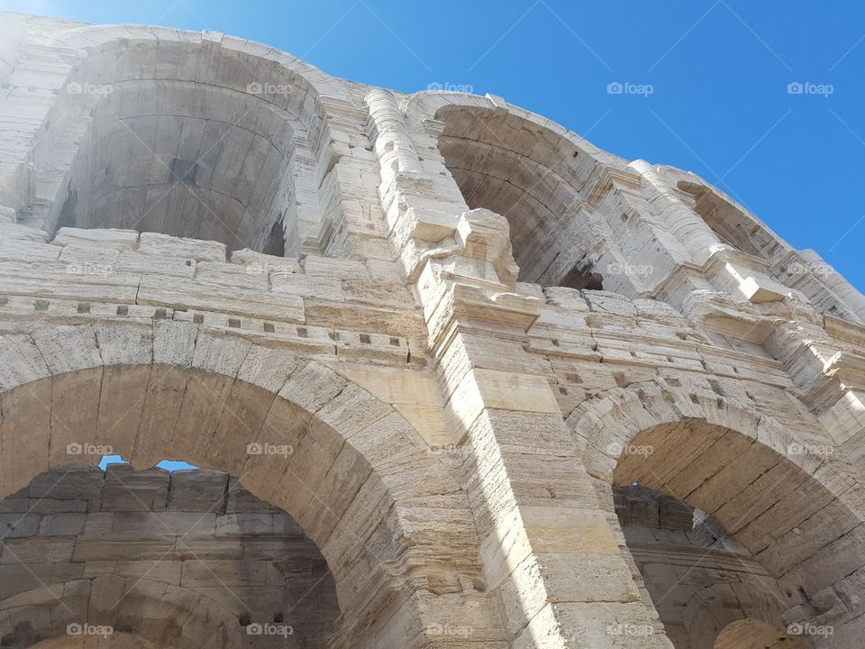 old stone round Roman bull fighting architecture landmark Arles sunny tourist attractions