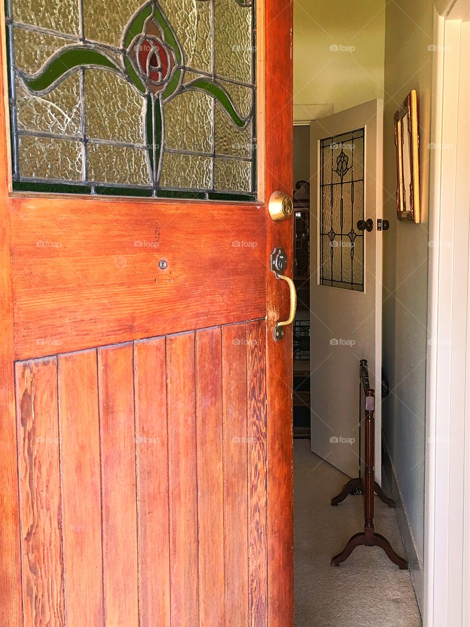 Antique wood and stained glass door opening into foyer of old home in south Australia 