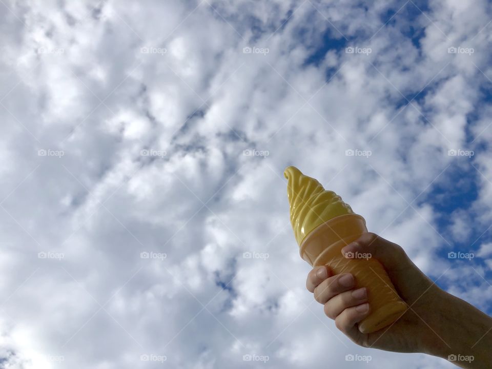 The child is holding a toy ice cream 