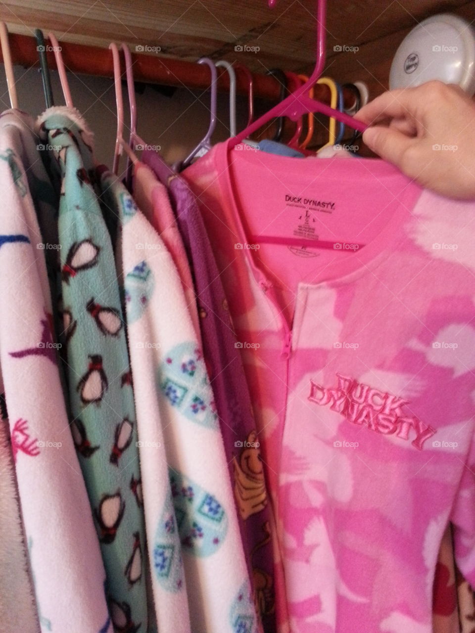 Hanging up pink Duck Dynasty Pj's. Hanging up laundry