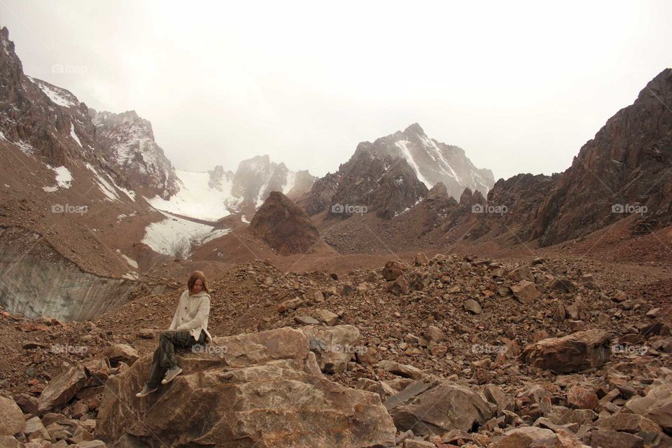 Girl resting on a halt on a glacier in the mountains