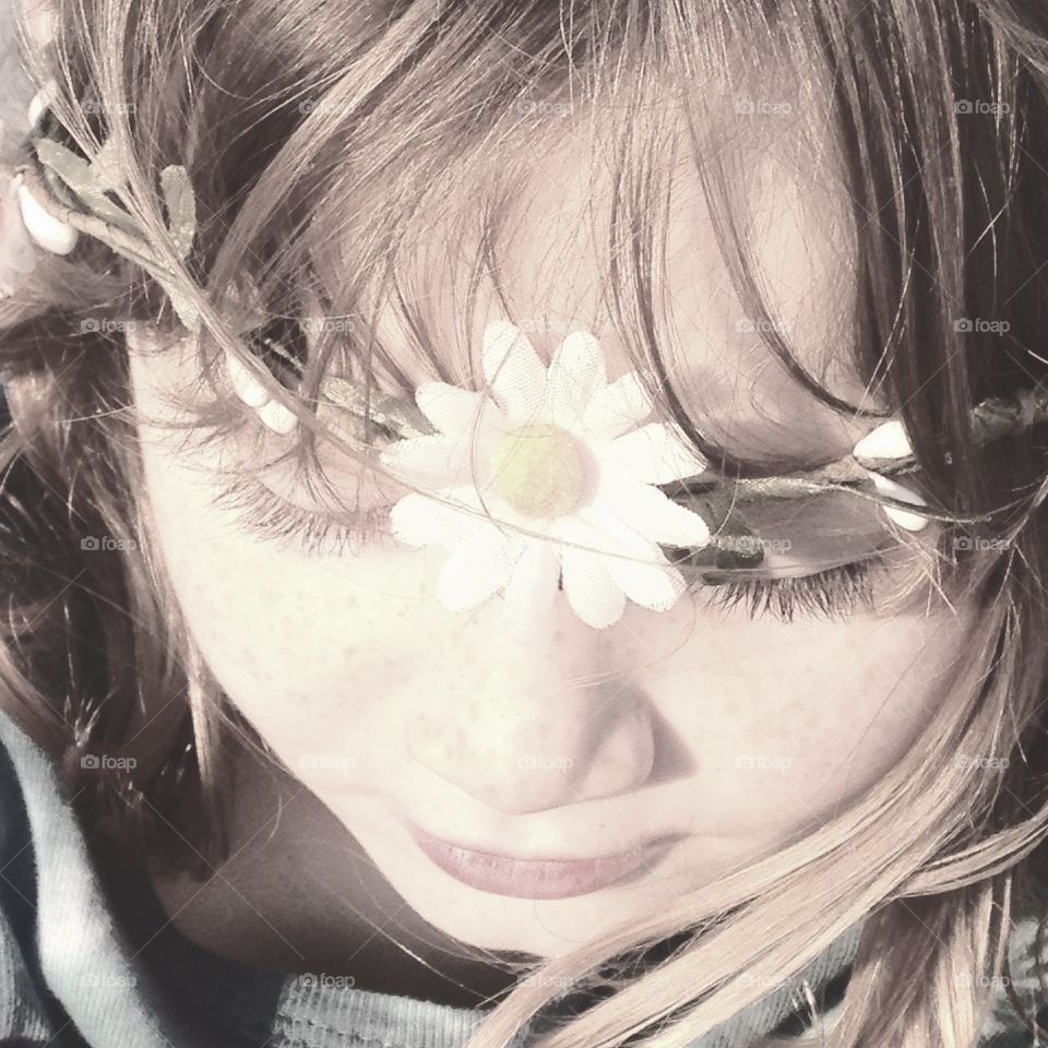 Close-up of a girl with floral head wear