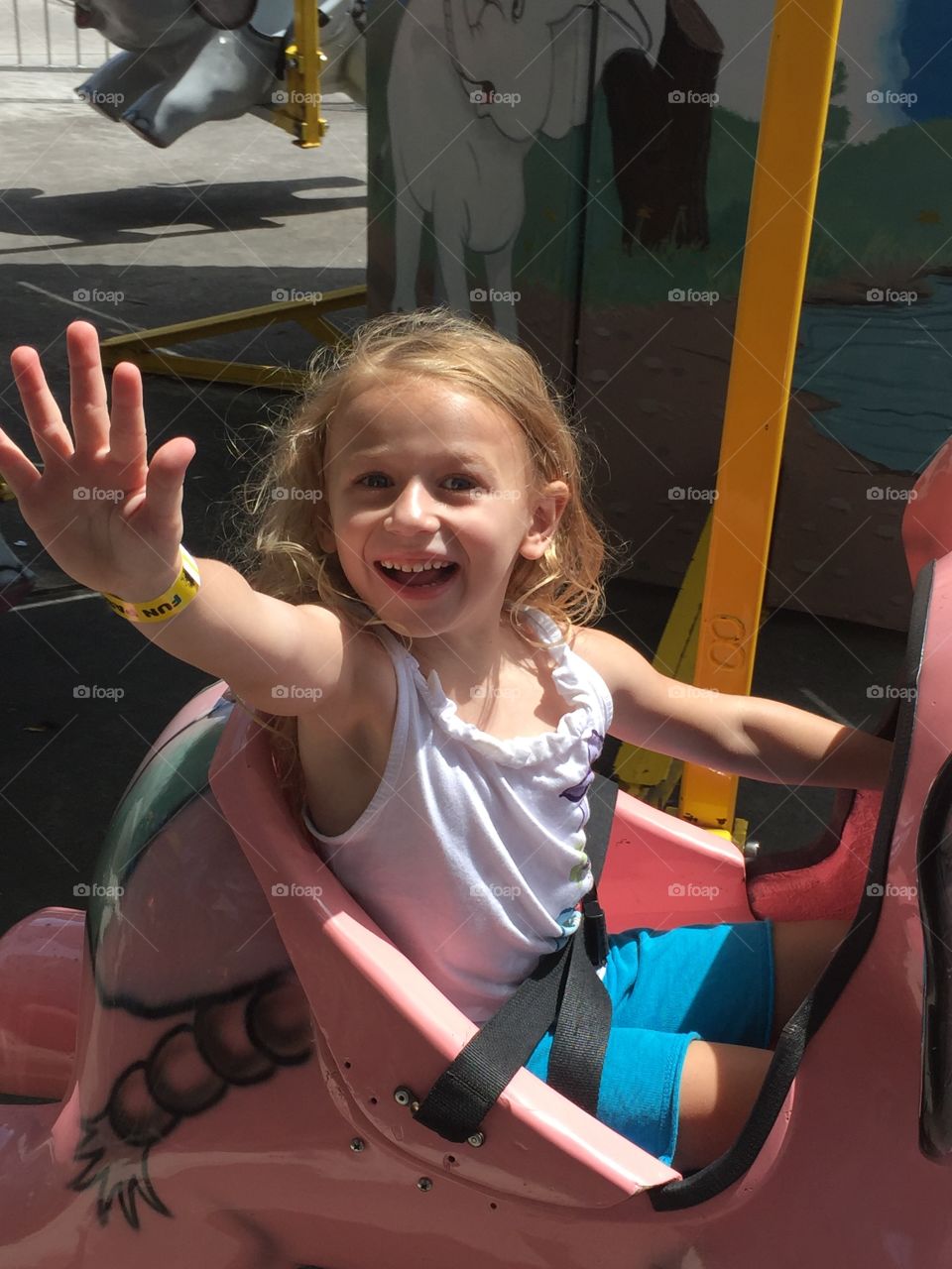 Small child playing on carousel