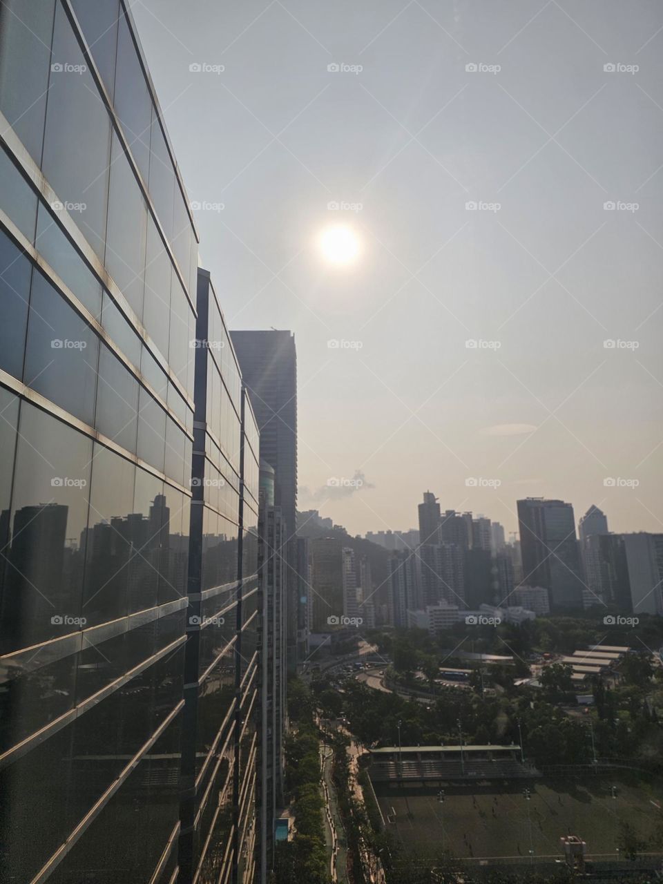 reflection of buildings on a building on a sunny day in Hong Kong