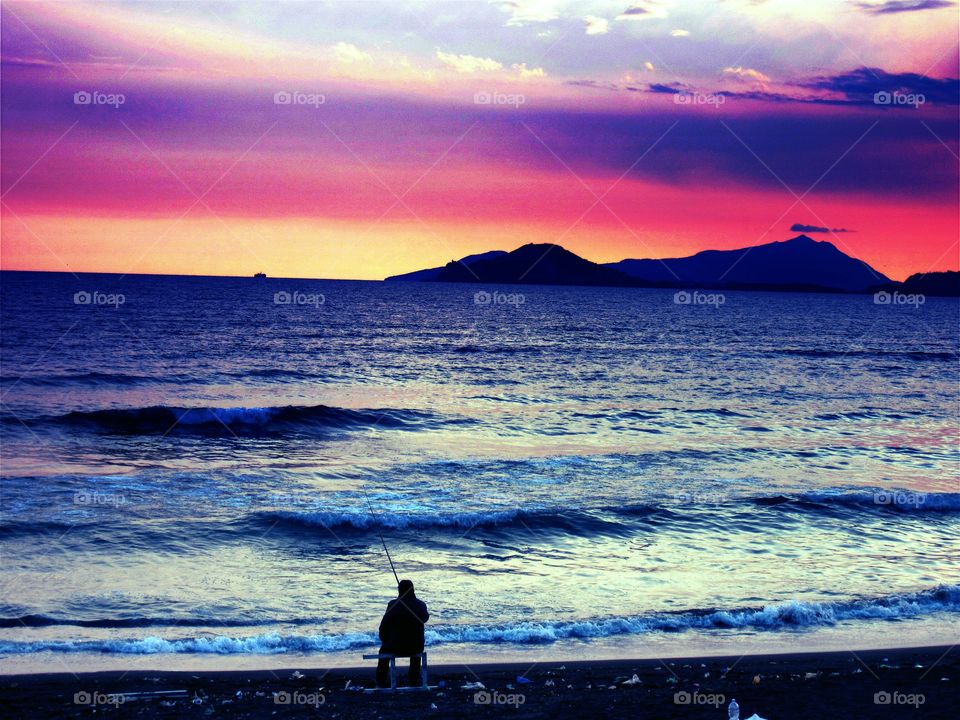 The fisherman and the water of the sea of Bagnoli ( Naples - Italy ).