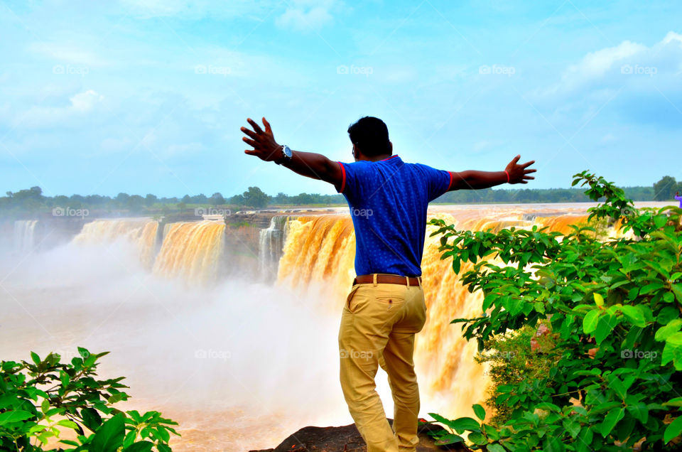 boy enjoying waterfall