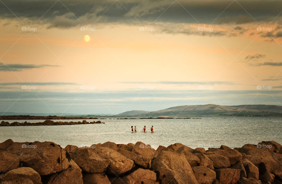 Swimming at Silverstrand beach under the moon at Galway, Ireland