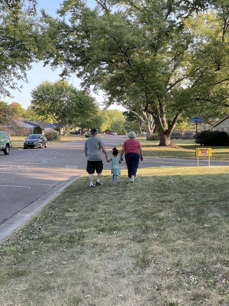 Little girl walks with grandma and grandpa, walking with grandparents, loving your grandparents, spending time with your grandma and grandpa 