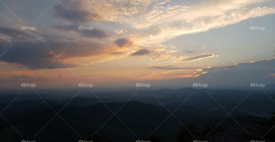 Sunset overlooking the Blue Ridge Mountains as fog sets in the valley.