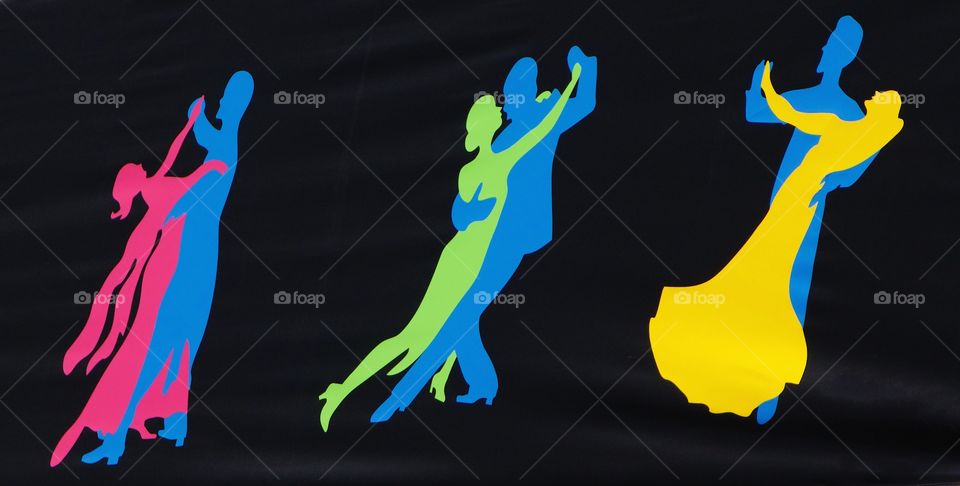 Silhouettes of pairs of ballroom dancers