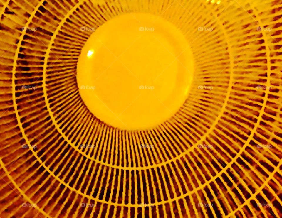 Closeup photo of a fan.yellow  and bright.