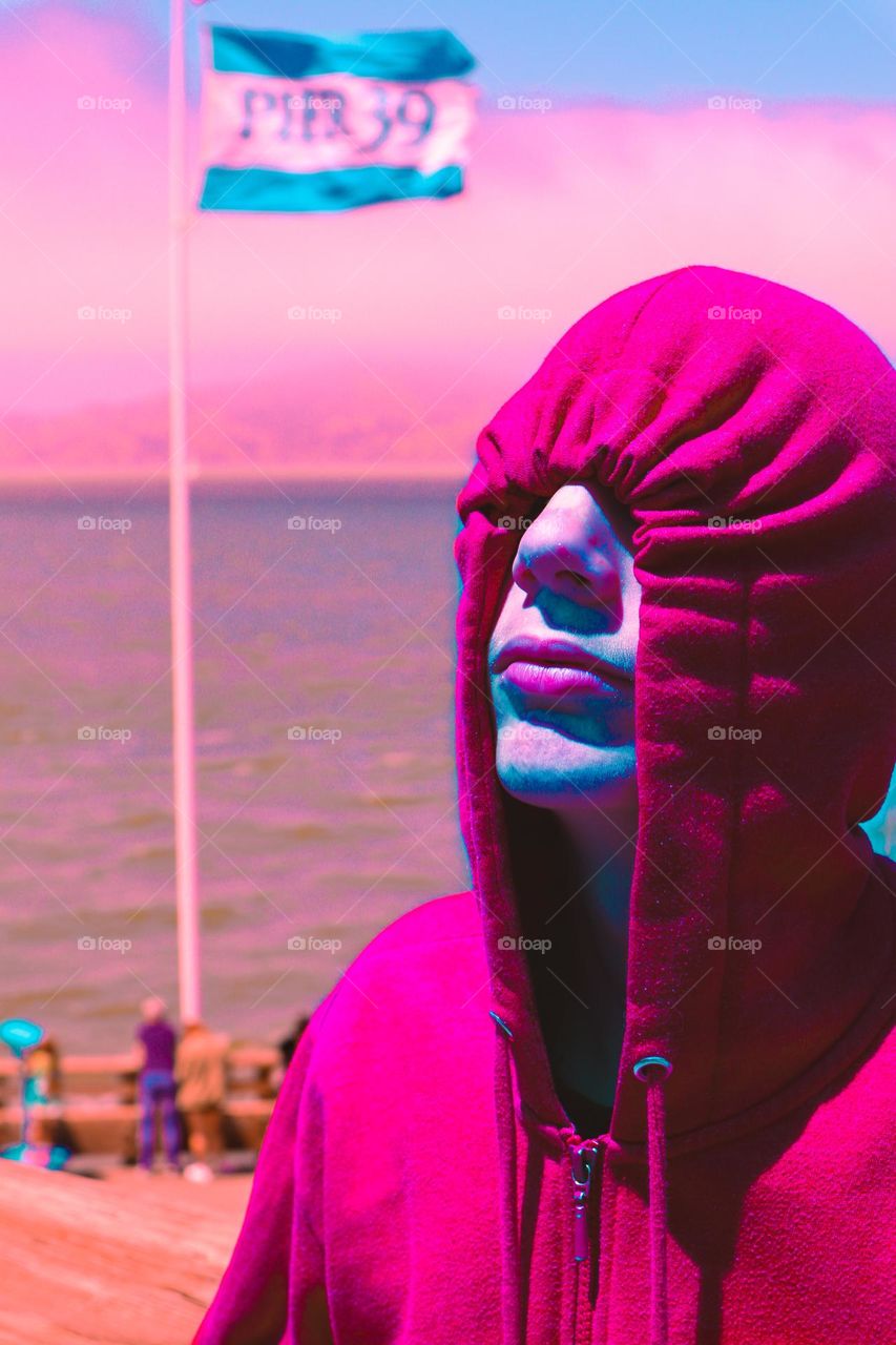 Pretty in pink hiding from the sun in his hoodie on pier 39