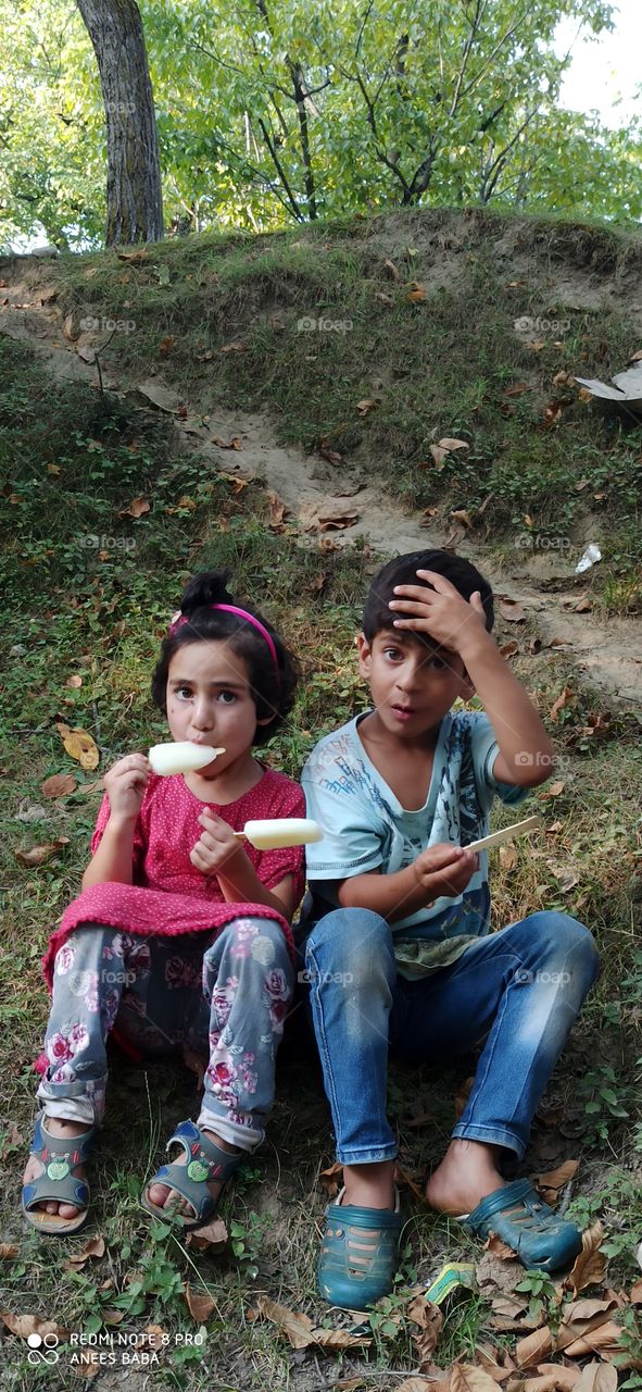 Beatiful & Innocent Children of a rural area enjoying local Ice Creams in very Hot mid Summer season in Kashmir Valley J&K India....