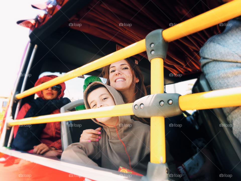 Mother and son travelling on bus