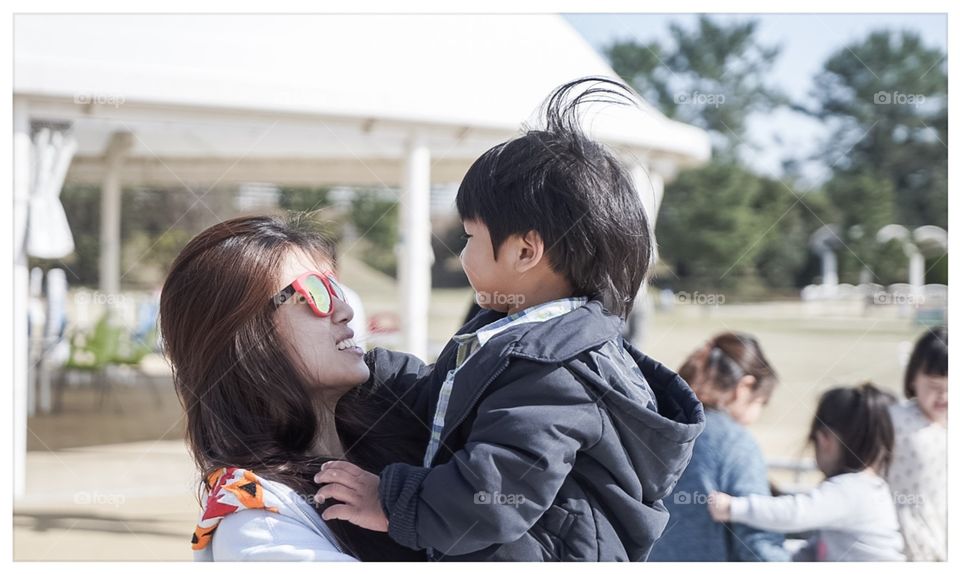 Japanese mother holding her love son